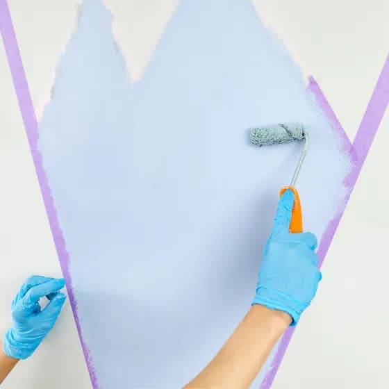 Painter applying a coat under supervision
